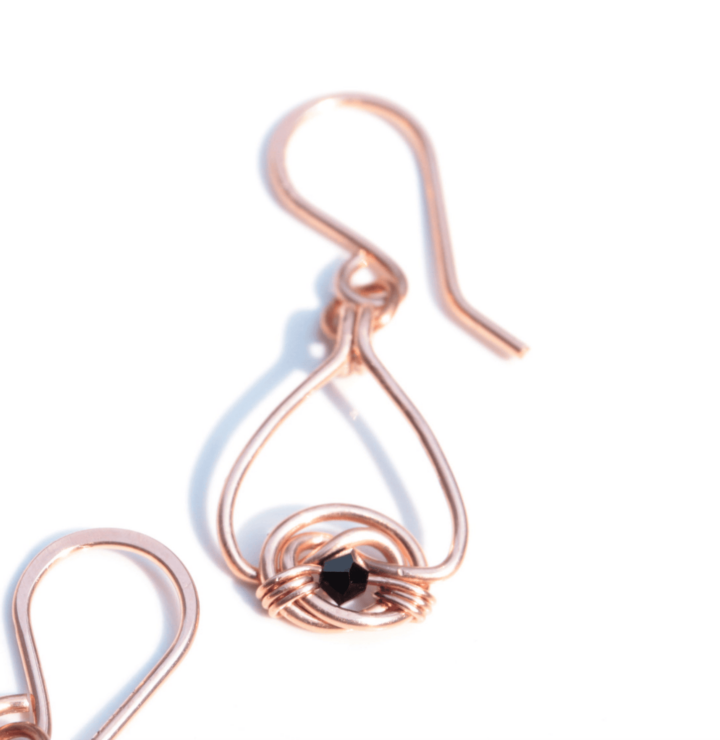 Copper double coin knot dangle earrings with black onyx beads hand made in USA Carrie Foscato design