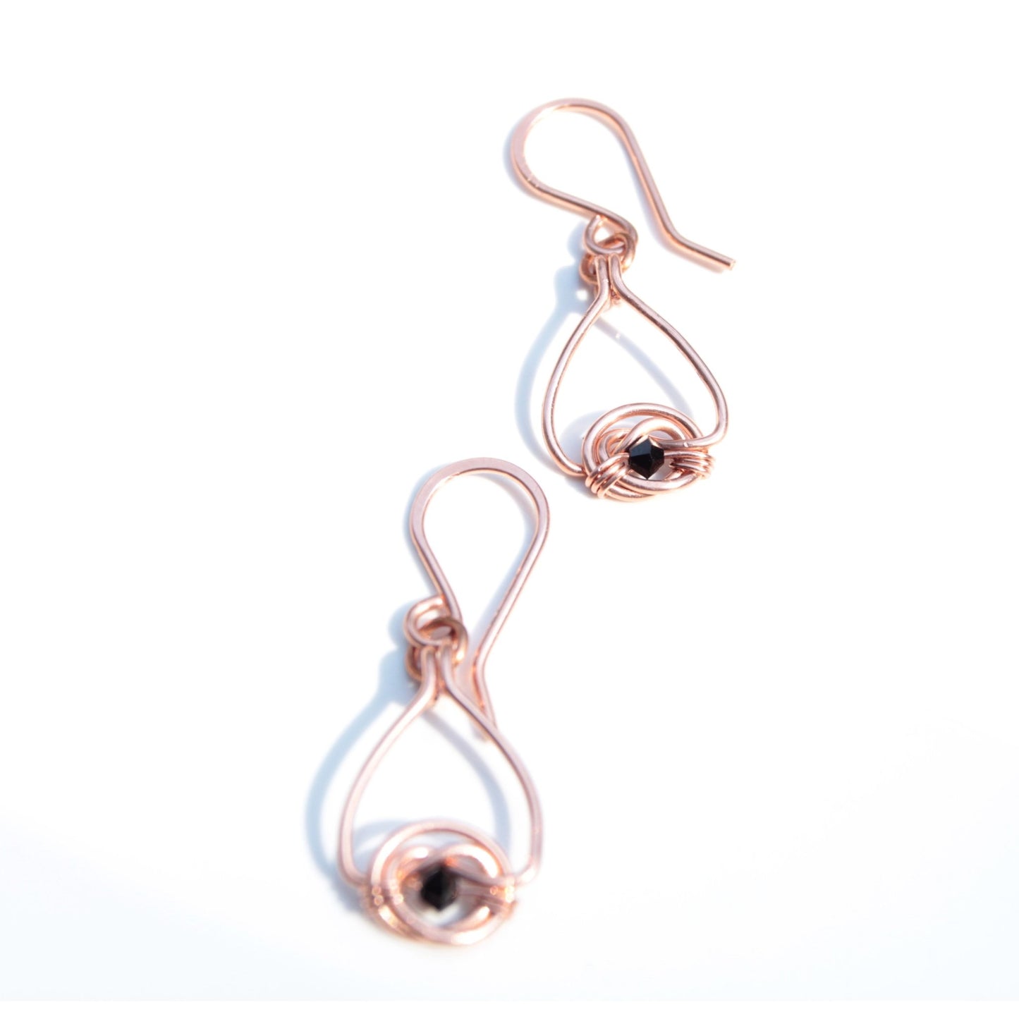 Copper double coin knot dangle earrings with black onyx beads hand made in USA Carrie Foscato design