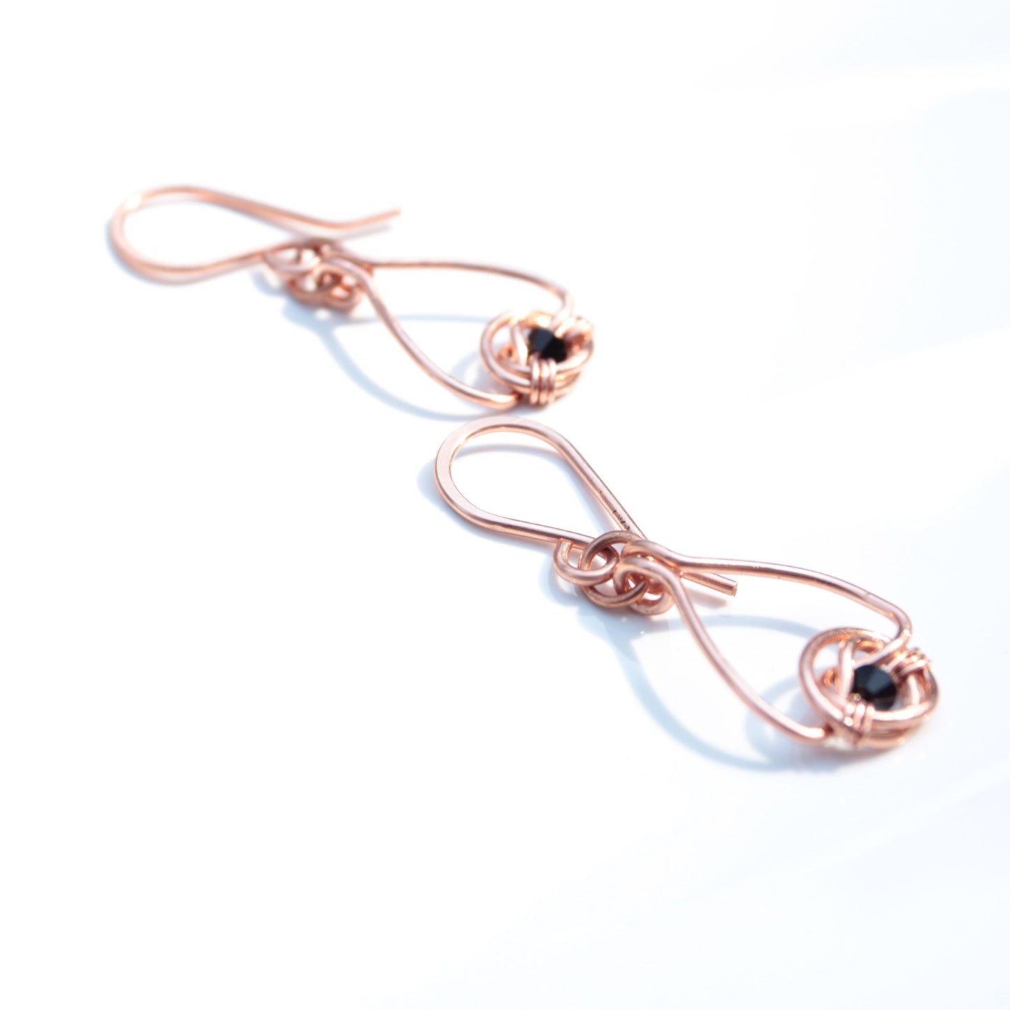 Copper double coin knot dangle earrings with black onyx beads hand made in USA Carrie Foscato design