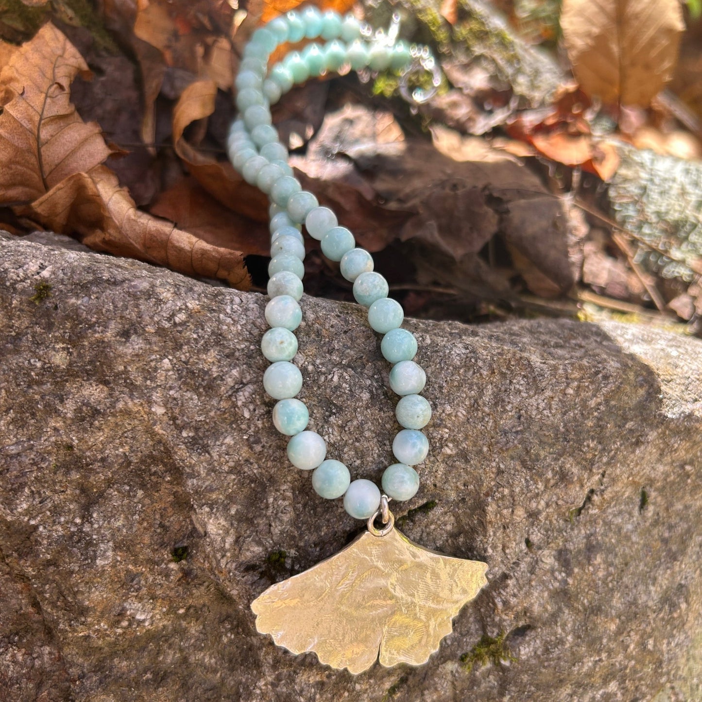 handmade fine silver ginkgo leaf pendant on a strand of aquamarine 8mm beads fasted with a sterling silver toggle clasp carrie foscato design made in USA